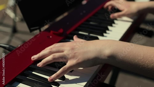 Piano playing. Keyboard player at a street concert. Fingers hit the keys. Musical melody.