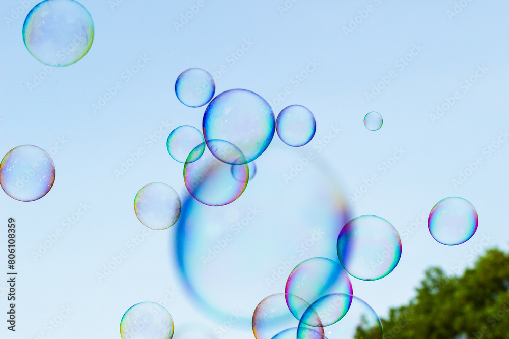 soap bubbles against the sky, reflection of the sun in the bubbles, color play, abstraction