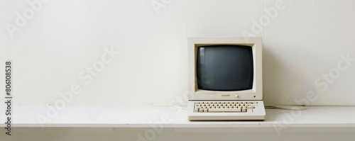 Clean white minimalist space with a vintage desktop setup tranquil homage to legacy computing photo