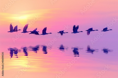 A flock of Anhanguera flying together at sunrise, their silhouettes against the colorful sky. The background features a serene lake reflecting the morning colors