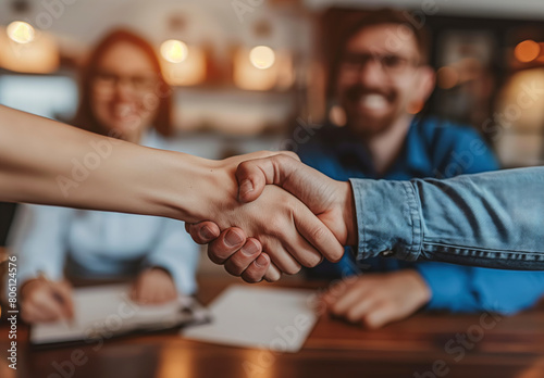 Successful Business Handshake: A smiling man and woman seal a deal in a professional setting, embodying teamwork and succes photo