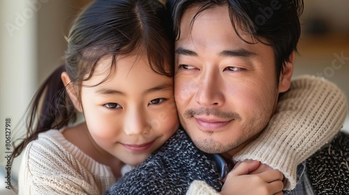 Comfortable and joyful portrait of an Asian father and daughter, their chemistry palpable photo