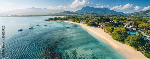 Aerial drone view of 5 star resort Shangri - La Le Touessrok with sandy beach, white villas, sailing boats and mountain range in the background, Ilot Lievres, Flacq, Mauritius photo