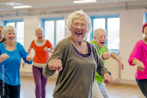 A group of cheerful, smiling elderly persons dancing in a studio. Shallow depth of field
