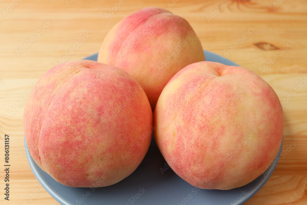 Closeup of Fresh Ripe Peaches on Wooden Table Closeup of Fresh Ripe Peaches on Wooden Table