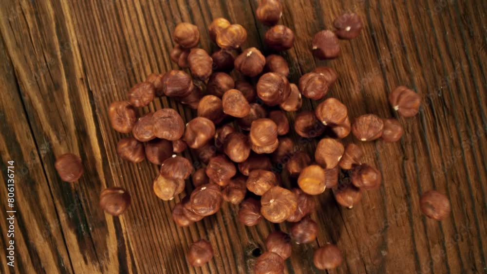 Super Slow Motion of Flying Hazelnuts over Wooden Planks. Camera Tracking the Target. Filmed on High Speed Cinema Camera, 1000fps. Super Slow Motion of Flying Hazelnuts over Wooden Planks. Camera Tracking the Target. Filmed on High Speed Cinema Camera, 1000fps.