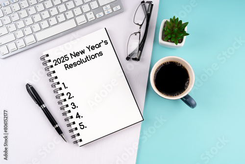 High angle view of 2025 New Year's Resolutions text on notepad
