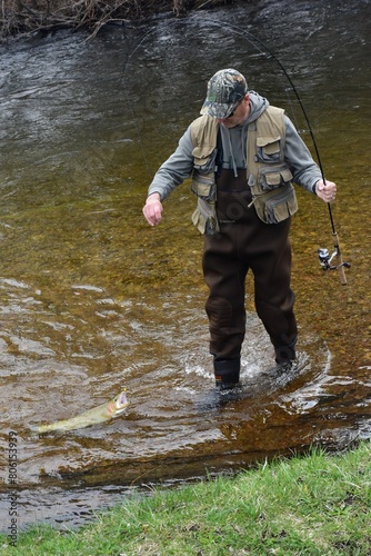 Angler catching a trout