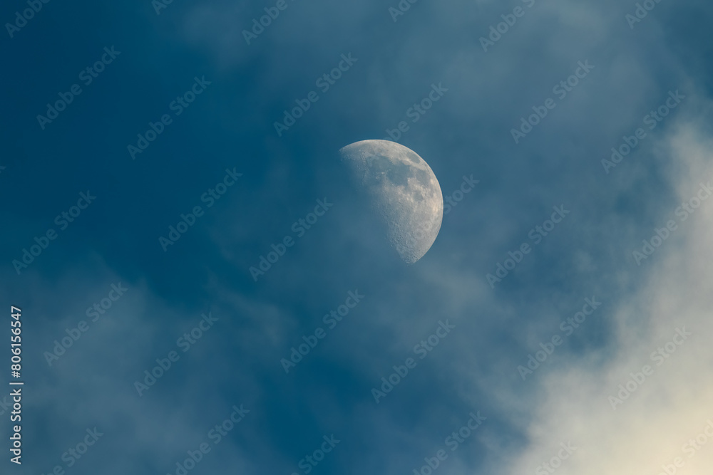 The moon in the evening sky with clouds. The moon in the evening sky with clouds.