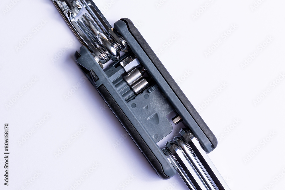 Black bicycle multifunctional multitool unfolded on a white background. Chrome steel tools. Tools for bicycle self-repairing .