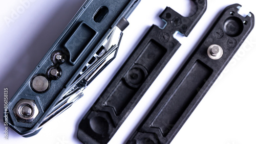 Obraz na płótnie Black bicycle multifunctional multitool unfolded on a white background. Chrome steel tools. Tools for bicycle self-repairing . w salonie