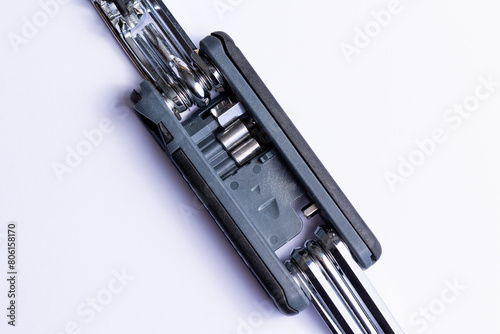 Obraz na płótnie Black bicycle multifunctional multitool unfolded on a white background. Chrome steel tools. Tools for bicycle self-repairing . w salonie