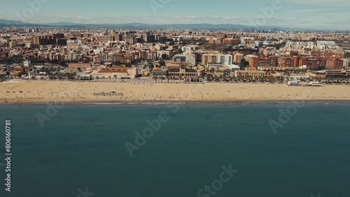 Drone flight over the Valencia sea. Valencia beach by drone. Valencia city taken by drone. Sunny day Beach by drone. People rest at the beach in a sunny day.