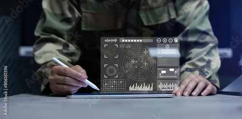 soldier man use stylus pencil to check program of radar and radio aviation for test system of tracking and defense at the dark control room center in monitor station for military technology concept