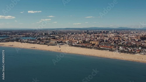 Drone flight over the Valencia sea. Valencia beach by drone. Valencia city taken by drone. Sunny day Beach by drone. People rest at the beach in a sunny day.