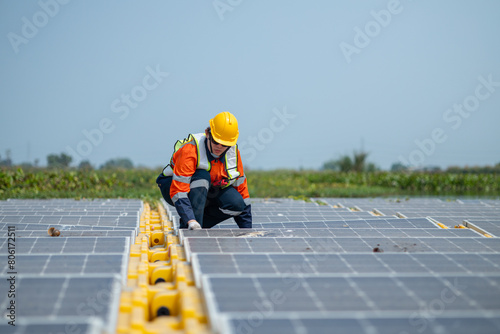 Wallpaper Mural Engineer Inspecting Solar Panels at Power Plant Torontodigital.ca
