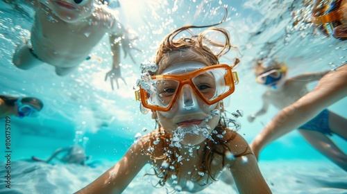 A wide-angle underwater photograph captures the joy of two children swimming and exploring in a large pool. Equipped with masks  © cristian