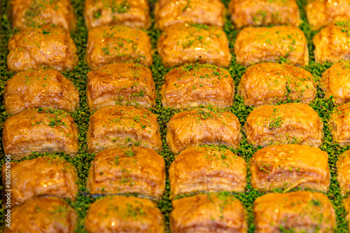 Turkish Pakhlava dessert. Close up of sweet turkish delishes for sale in a market stall in Istanbul, Turkey. Selective focus © welcomeinside