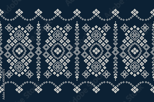 Traditional ethnic motifs ikat geometric fabric pattern cross stitch.Ikat embroidery Ethnic oriental Pixel navy blue background. Abstract,vector,illustration. Texture,decoration,wallpaper.