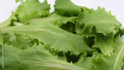 pile of green lettuce leaves,foglie di lattughino verde,macro close-up,rotary video photo