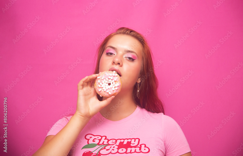 girl eating donut with pink cream girl eating donut with pink cream