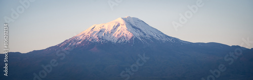 Panoramic shot of massive standalone mountain with snow cap during colorful sunset, Eastern Turkey