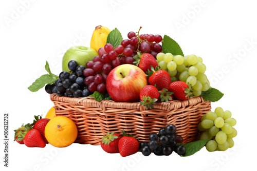 A wicker basket filled with fresh fruits including apples, grapes, strawberries, and oranges. © Kasitthanin