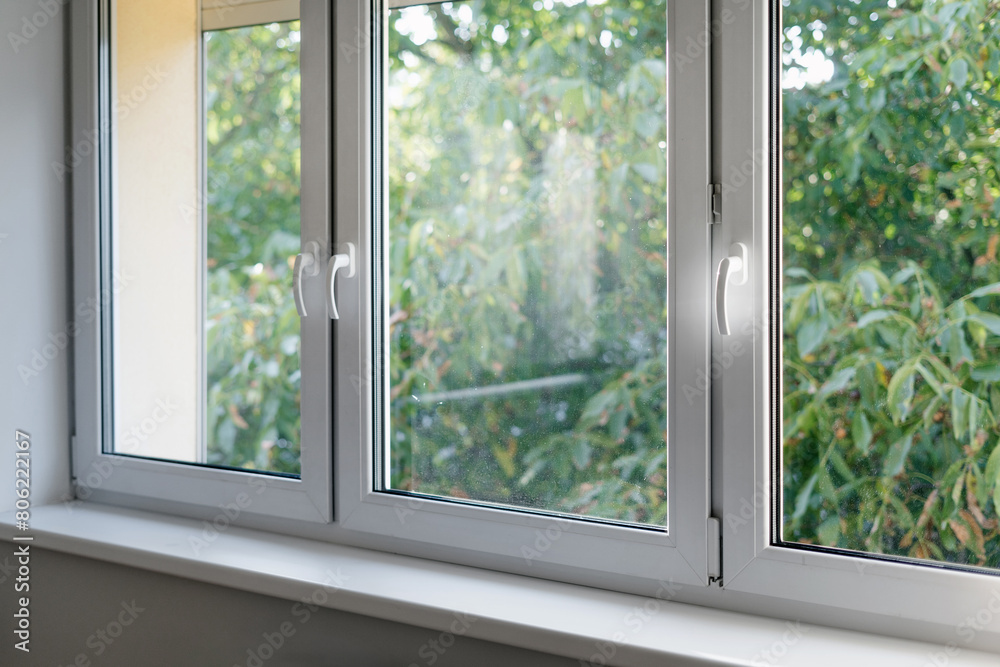 White window frame with modern aluminium profiles in bedroom White window frame with modern aluminium profiles in bedroom