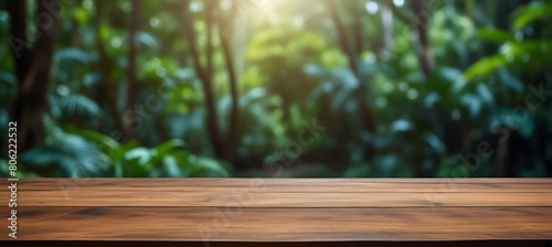 The empty wooden table top with blur background of Amazon rainforest. Exuberant image.
