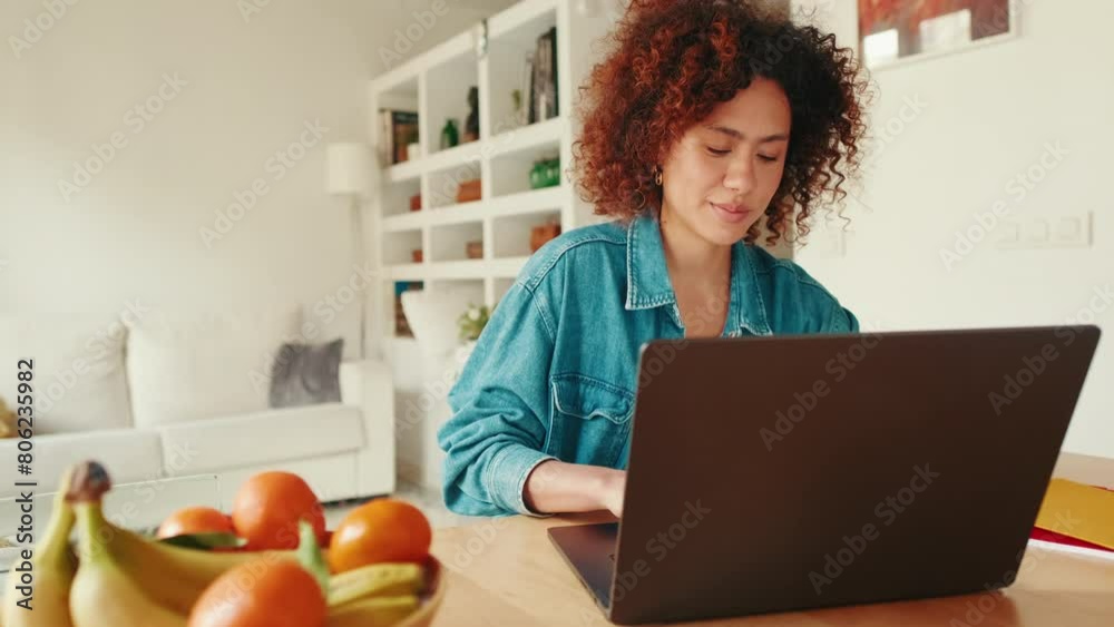 Woman writing blog on laptop computer