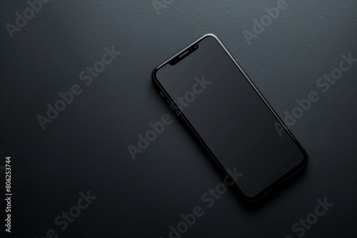 A black iPhone is sitting on a dark surface, free space for text
