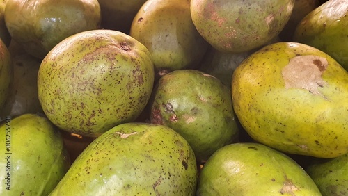 Close up pile of tasty fresh avocados sold at the market as a background.