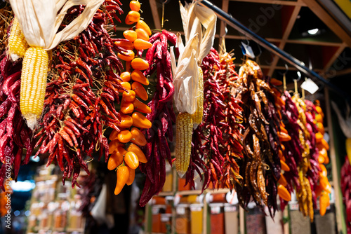 Dry red spicy peppers hanging on strings. Close up of bunch dried pepper at the local market. Calabrian pepper photo