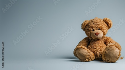 Teddy bear alone on clean background symbolizing childhood nostalgia and innocence. Concept of loneliness and lost youth