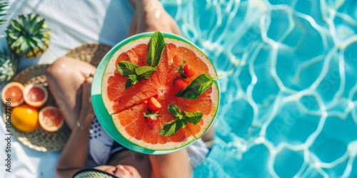 Person Holding Watermelon Slice by Pool