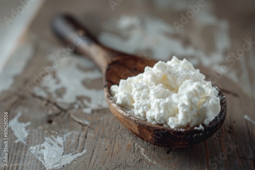 Cottage cheese delicately scooped onto a vintage wooden spoon, highlighting its creamy texture on a table