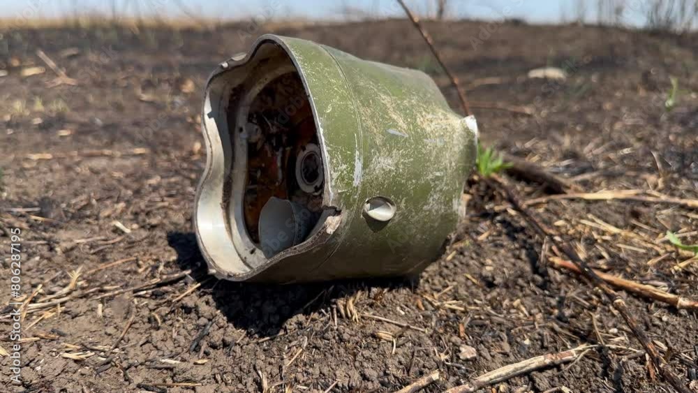 Control unit for rocket munition that lies among the burnt earth in forest plantation with burnt trees. War in Ukraine Control unit for rocket munition that lies among the burnt earth in forest plantation with burnt trees. War in Ukraine