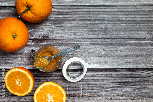 Tasty and healthy homemade orange marmalade. Top view of a table with a jar of homemade orange marmalade.