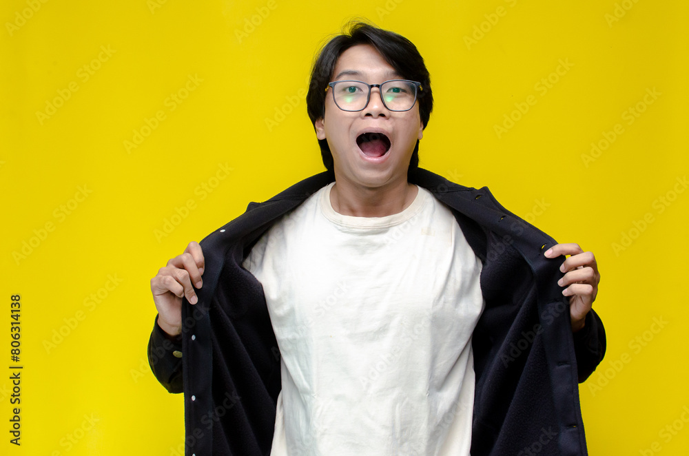 Wow and surprised face of young asian man feeling happy, excited and positive. asian man with glasses feels shock with wow surprised expression. Wow and surprised face of young asian man feeling happy, excited and positive. asian man with glasses feels shock with wow surprised expression.