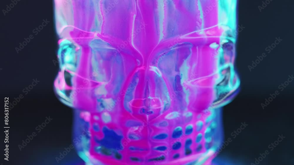 Paint skull. Ink drip. Occult cranium spell. Defocused neon pink blue color glowing fluid spill spooky glass skeleton head on dark black abstract art background. Paint skull. Ink drip. Occult cranium spell. Defocused neon pink blue color glowing fluid spill spooky glass skeleton head on dark black abstract art background.