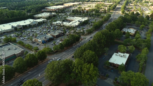 Aerial view of an upscale area in suburbs of Atlanta with busy roads and packedd parking lots of shopping center. photo