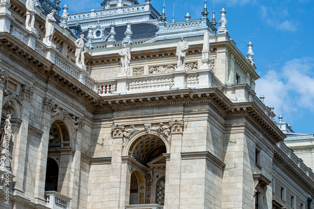 Obraz premium The Hungarian Royal State Opera House located in city center. Beautiful summer day, people on the street in Budapest, Hungary