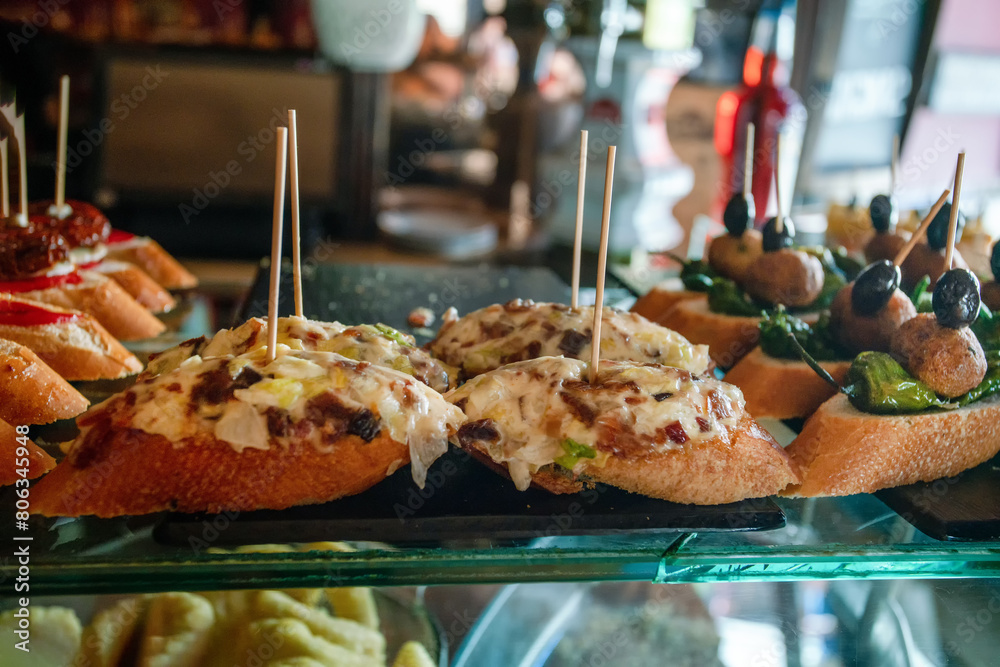 Fototapeta premium Tapas are Spanish appetizers, meant to be eaten in just a few bites. Traditional tapas include mixed olives, fried baby squid, neatballs and chorizo