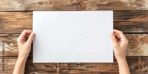ands Carefully Holding Blank White Paper for Display