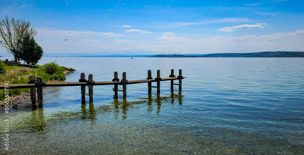 Beautiful view of lake Constance with transparent water and Swiss Alps on a sunny day