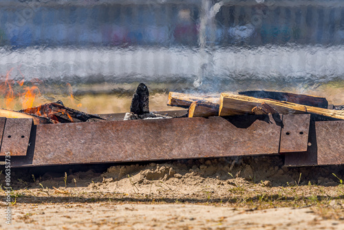 Obstacle from a burning bonfire. The bonfire is on the way for athletes. Air convection. Mixing of hot and cold air. A marathon with complications. Firewood for the fire. Barbecue season.