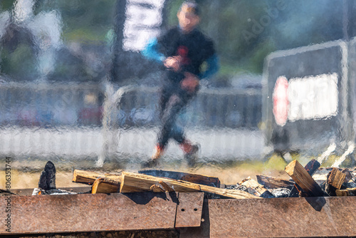 Obstacle from a burning bonfire. The bonfire is on the way for athletes. Air convection. Mixing of hot and cold air. A marathon with complications. Firewood for the fire. Barbecue season.