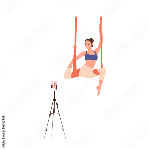 Young sportswoman cartoon character doing aerial yoga recording video tutorial for blog on phone