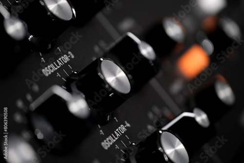 hardware music synthesizer , buttons and knobs of a vintage synth. Musical instrument, recording studio, studio gear, instruments close up, music