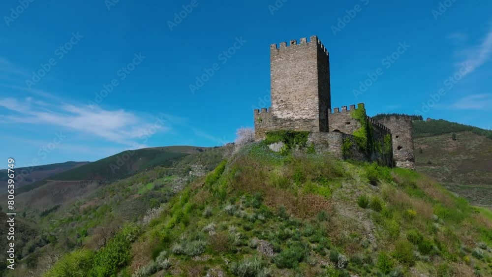 Low angle orbiting drone shot of Doiras Castle on a hill In Cervantes, Lugo, Spain on a sunny day Low angle orbiting drone shot of Doiras Castle on a hill In Cervantes, Lugo, Spain on a sunny day